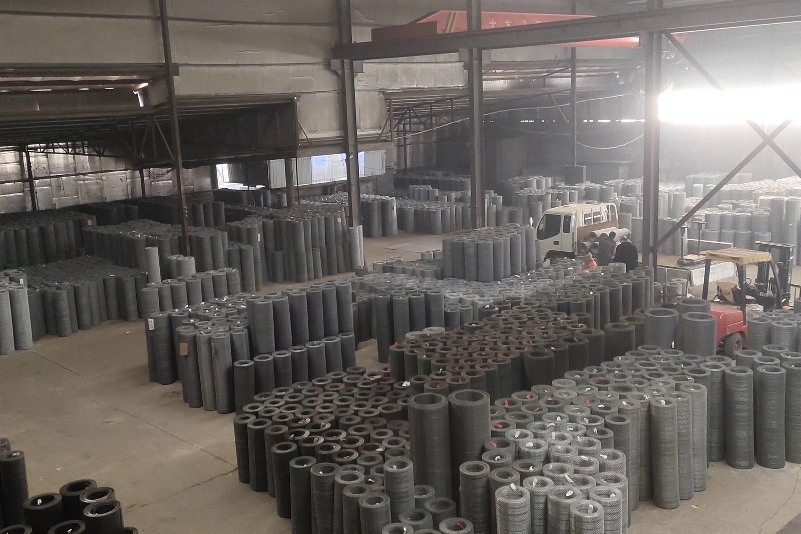 Woven wire screen rolls stored in the factory